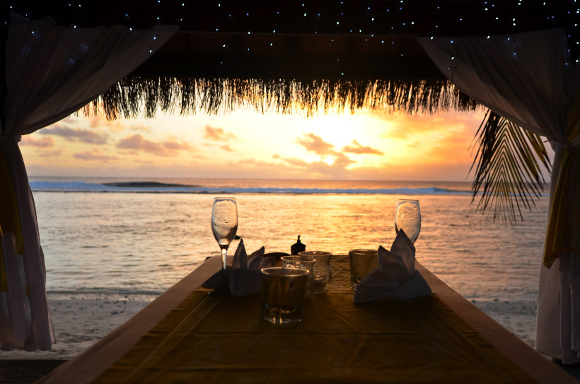 Travel Associates table with wine glasses sunset rarotonga
