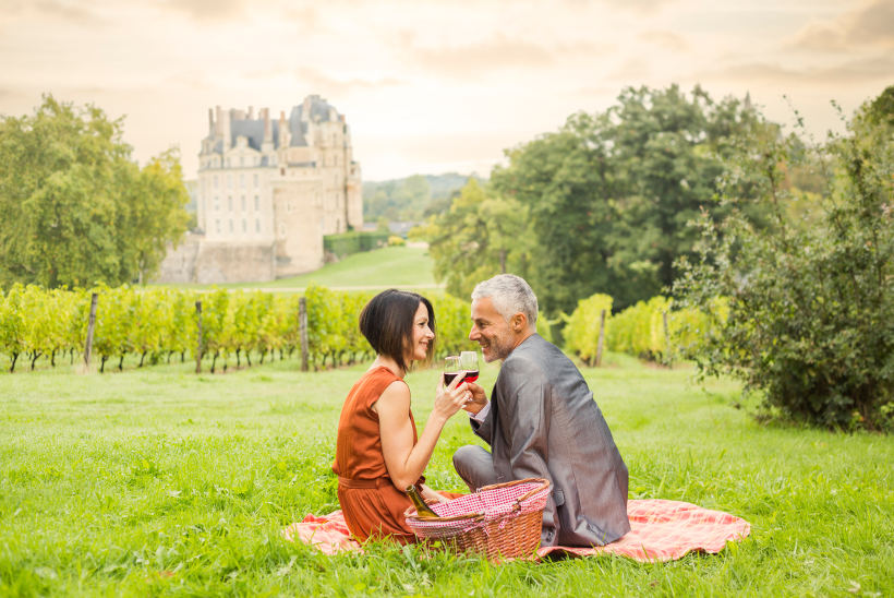 Travel Associates couple having picnic in french vineyard