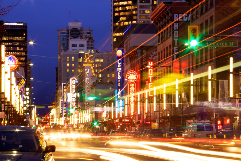 Granville Street in Vancouver at night, with bright lights and blurred traffic