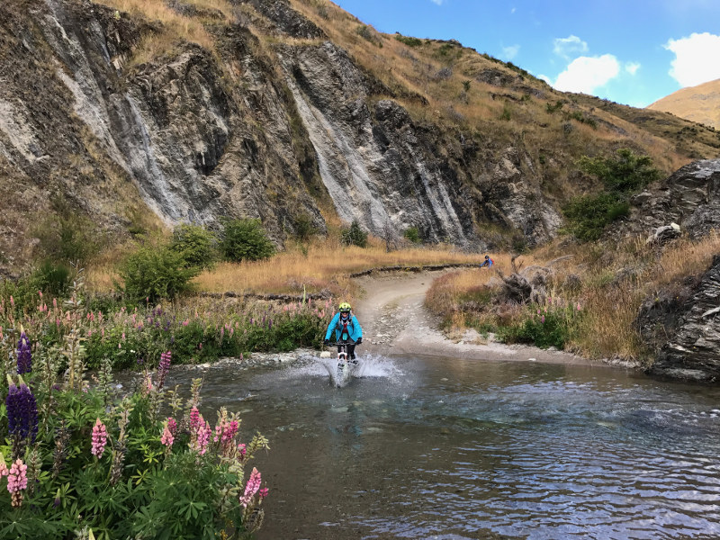 Mountain biking through stream