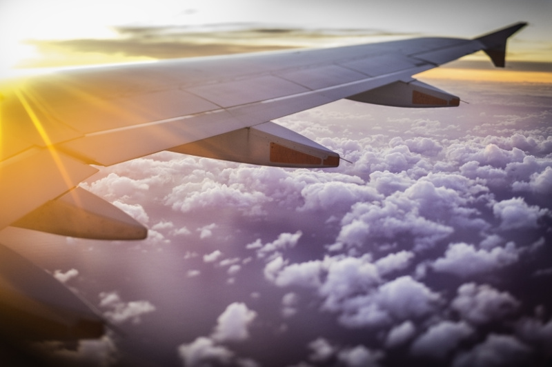 Plane wing with clouds