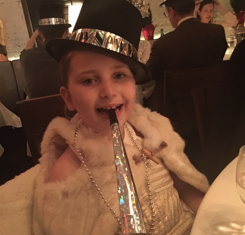 Young girl decked out in NYE finery