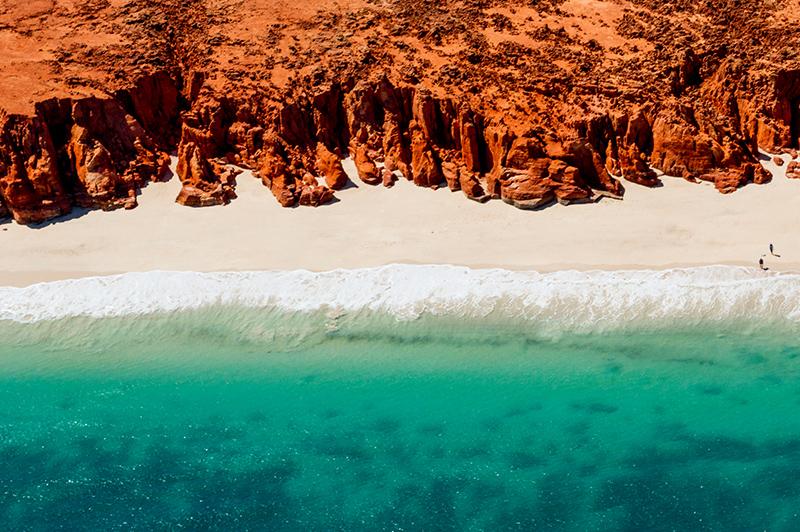 White sands, turquoise ocean and striking red Kooljaman Cliffs at Cape Leveque White sands, turquoise ocean and striking red Kooljaman Cliffs at Cape Leveque