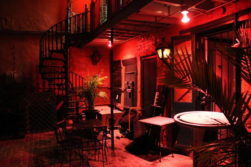 Cuban tango club red lights, palm tree in pot, empty