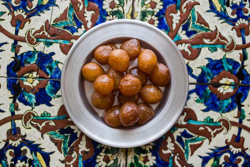 Delicious loukoumades - dense doughnut balls dipped in honey