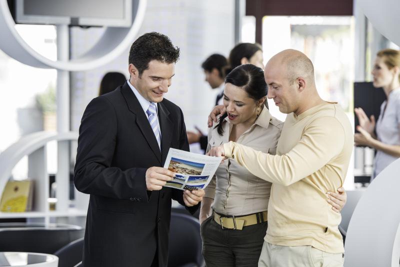 Couple talk to travel agent